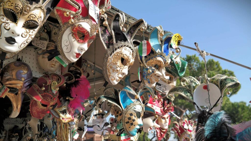 Festival masks hanging from a street vendor stand in Alicante, Spain