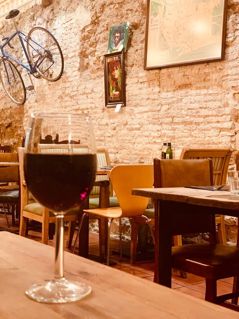 glass of red wine on table in Pepa Bar al Vins, tapas bar in Barcelona