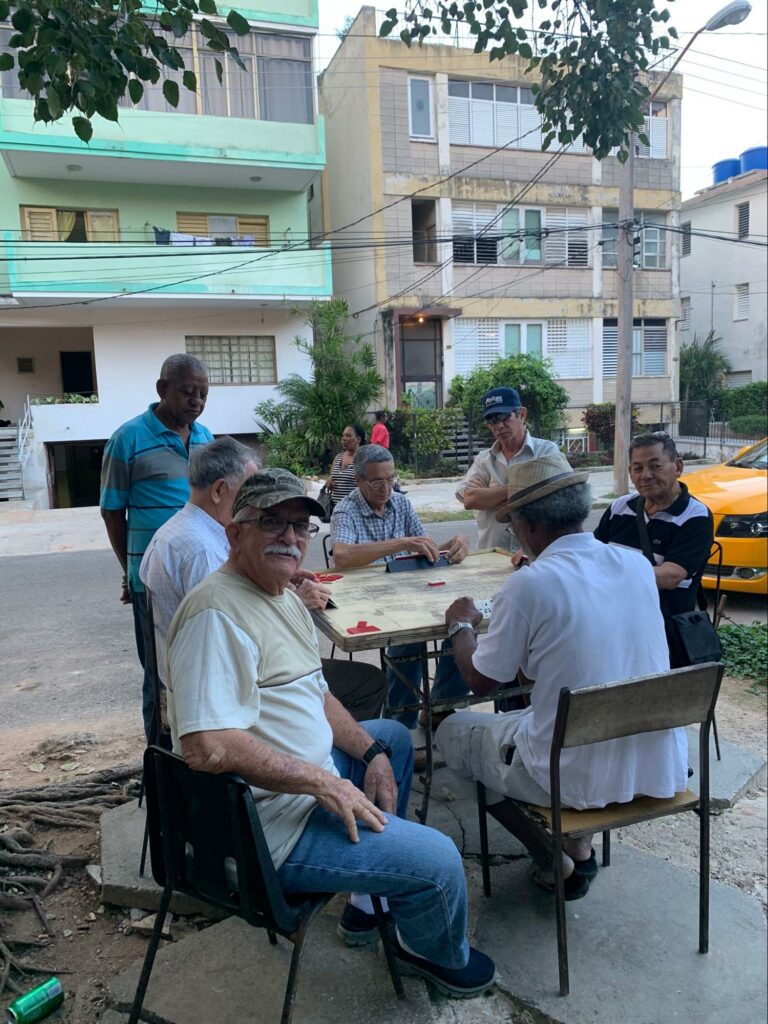Cuban locals being sociable and demonstrating a sense of community playing games in the street.